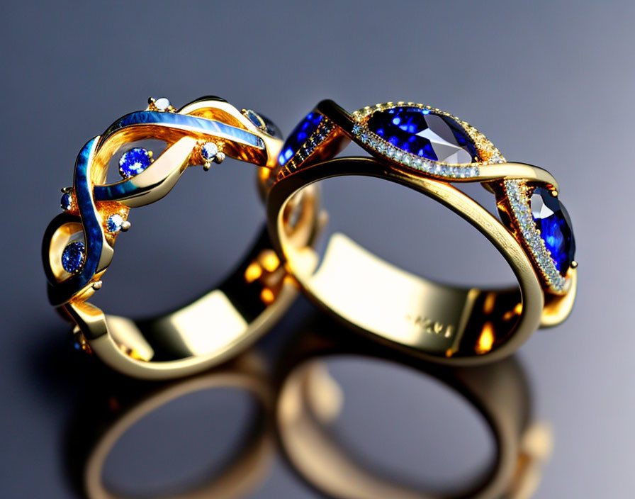 Elegant Gold Rings with Blue Gemstones and Diamonds on Reflective Surface