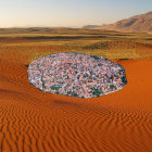 Futuristic desert city with radial streets and skyscrapers.