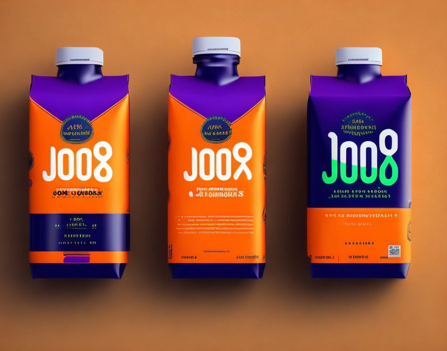 Three cartons of orange and purple "JOOƧ" brand beverage on brown background