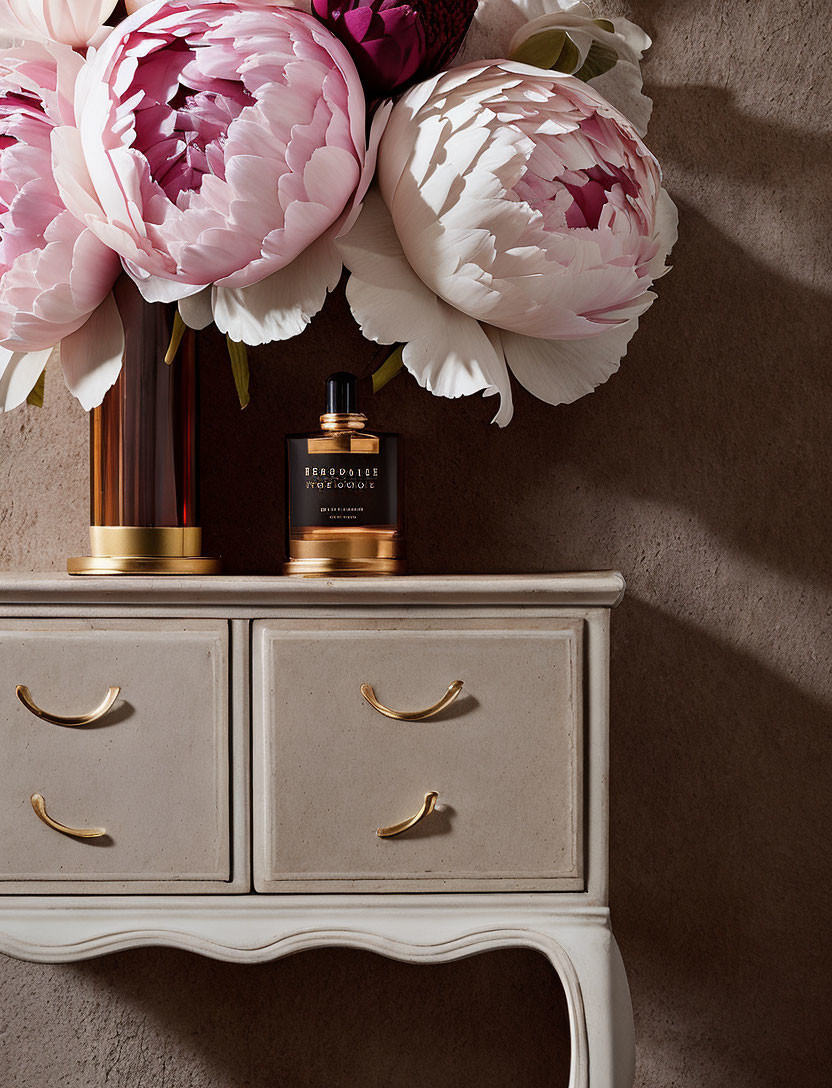 Elegant nightstand decor with pink peonies and perfume bottle on grey wall