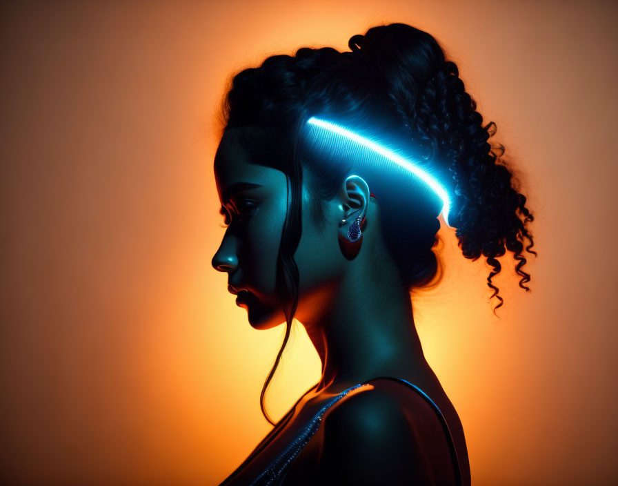 Silhouette of a Woman with Glowing Neon Light on Warm Background