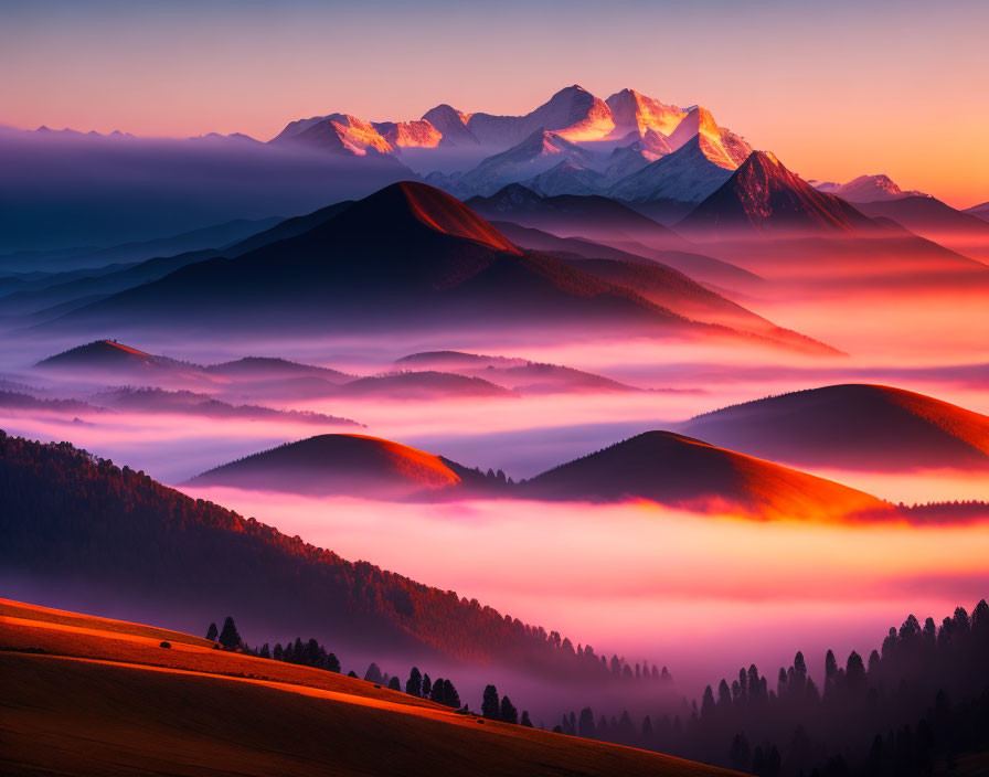 Scenic sunrise with mist-covered mountains and silhouetted ridges