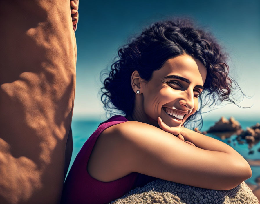 Smiling woman with windswept hair against blue sky