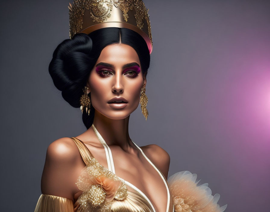 Woman with dramatic makeup, unique black hairstyle, gold accessories, crown, and elegant gown with feath