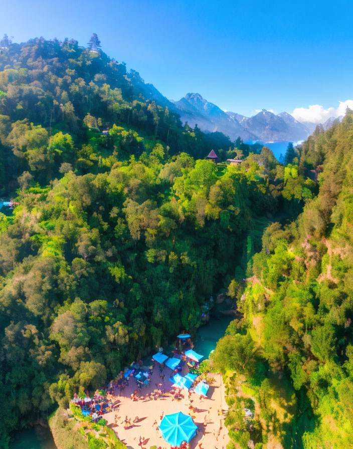 Scenic aerial view of lush green valley with river, people on sandy bank, colorful umbrellas,