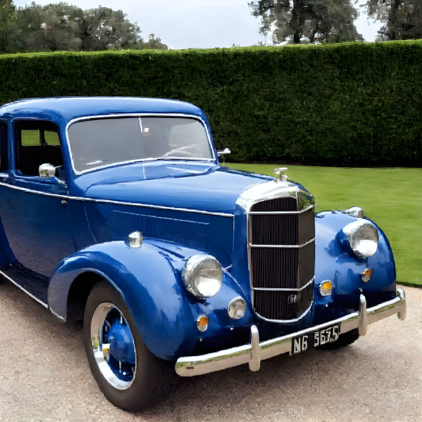 Vintage Blue Car Parked by Trimmed Hedge