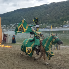 Historical military rider on horse with flag, soldiers, and castle scenery.