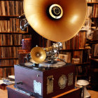 Vintage Gramophone with Large Brass Horn on Wooden Cabinet & Books and Records Shelf Display