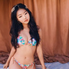 Portrait of a Woman in Bejeweled Bikini Against Draped Background