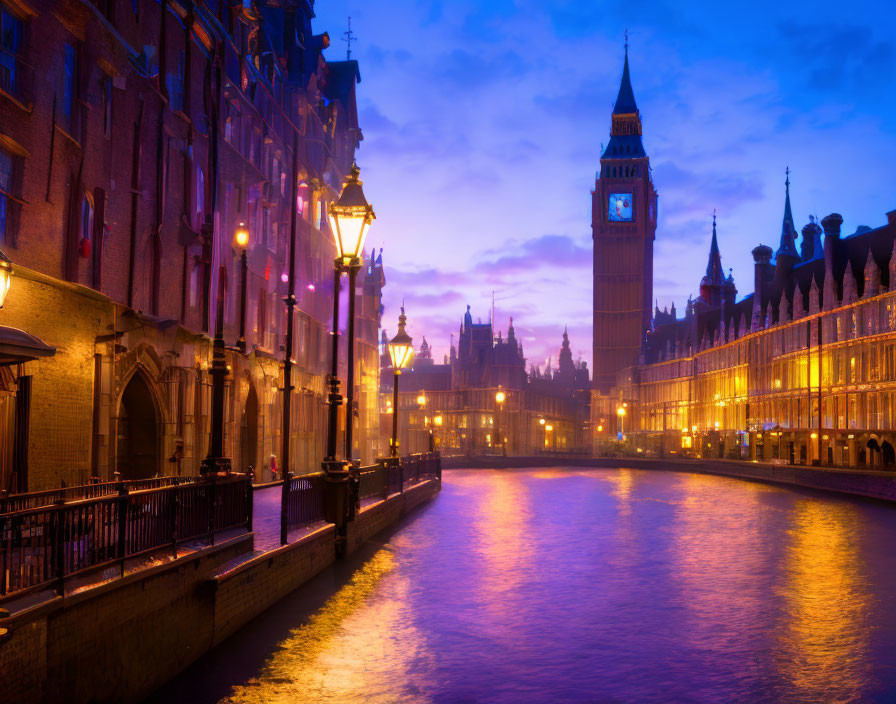 River with illuminated buildings and clock tower against dusky sky