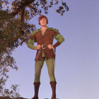 Red-haired animated character in green medieval outfit under blue sky with palm tree.