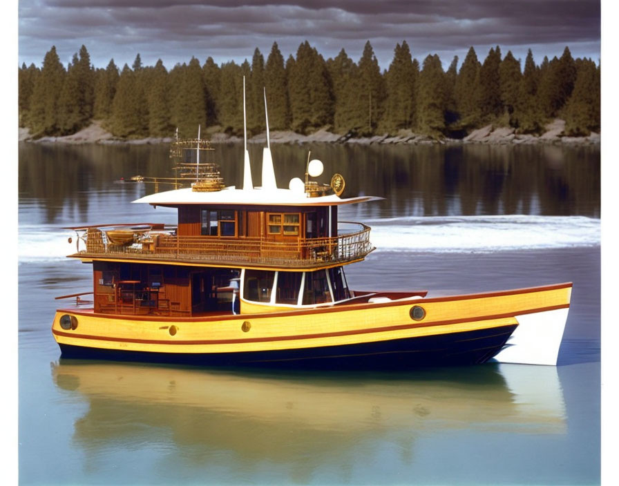 Wooden yacht with yellow stripe sailing near tree-lined shore