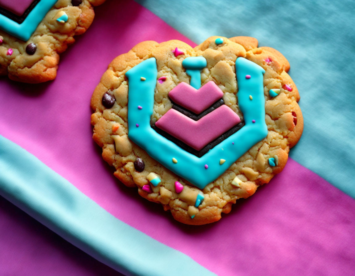 Colorful Cookie with Turquoise and Pink Fondant Crown Emblem on Pink and Blue Cloth