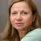 Woman Portrait with Medium-Length Hair and Soft Gaze in Light-Colored Outfit