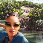 Digital Artwork: Woman with Sunglasses Posing in Front of Blooming Flowers and Beach