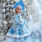 Traditional Russian matryoshka doll in blue cloak surrounded by snow-covered branches and falling snowflakes