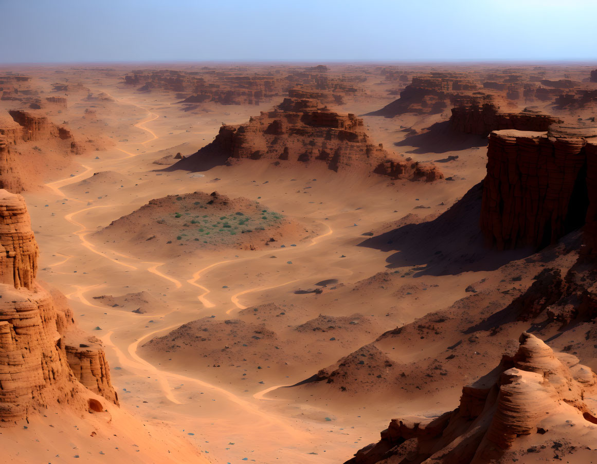 Desert landscape with winding sand tracks and towering rock formations