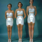 Three Women in White Dresses with Golden Sandals and Flowing Hair