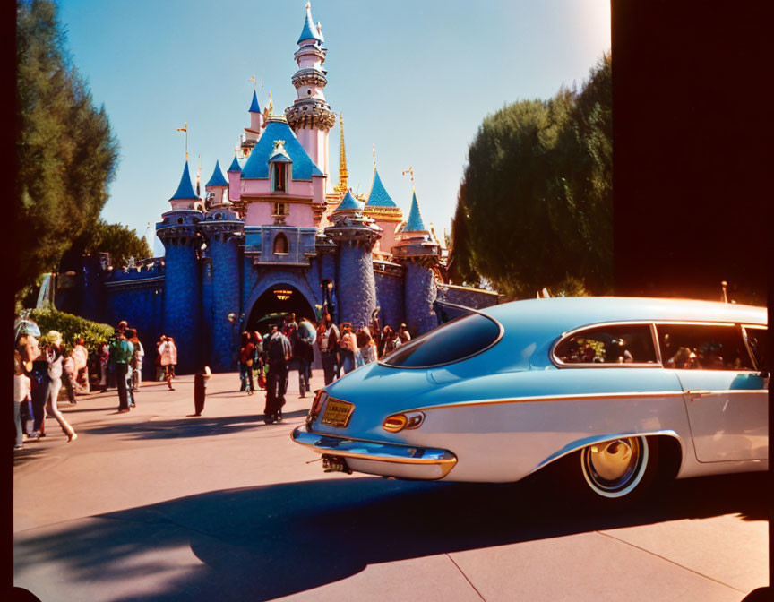 Vintage Blue Car Parked Near Fairytale Castle Entrance on Sunny Day