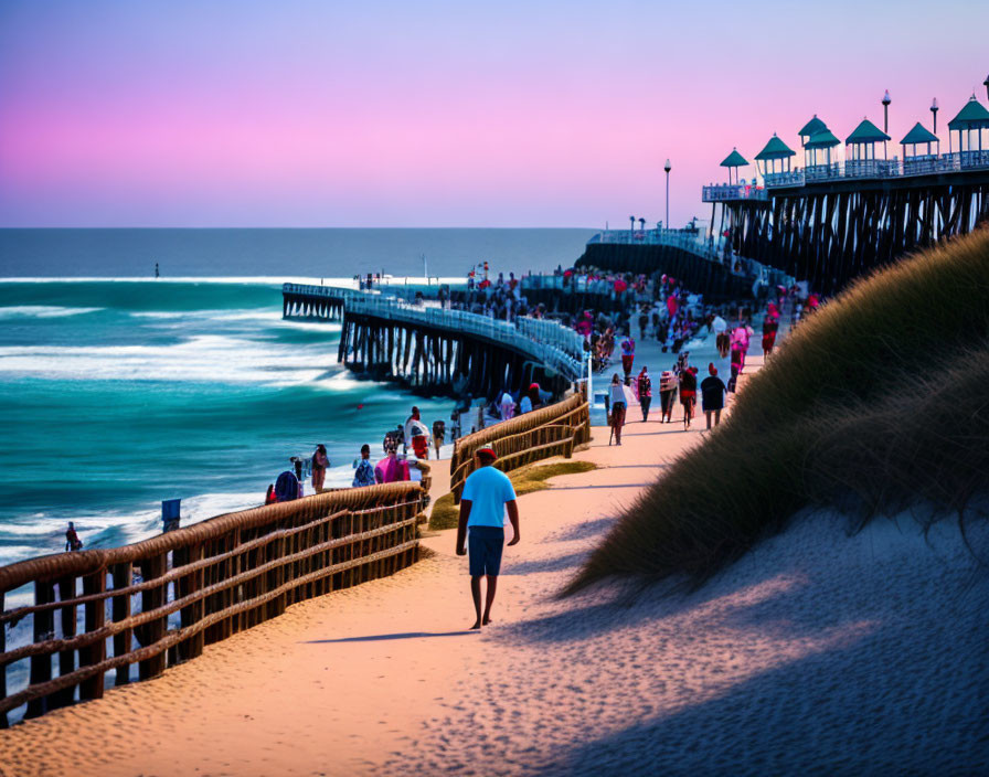 Seaside boardwalk at dusk with sandy dune and crowded pier