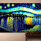 Framed painting of vibrant night sky reflected on water above wooden table