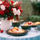 Tranquil garden breakfast scene with red and white roses, eggs, and pastries