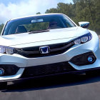 White Honda Car with Modern Design and Iconic Emblem Parked Outdoors