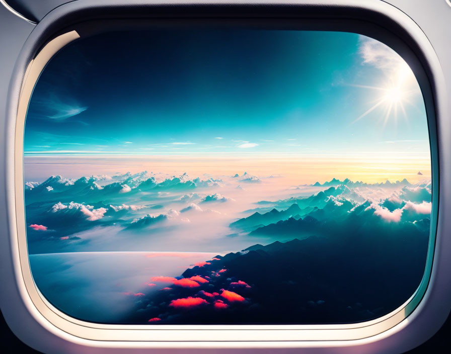 Airplane window view of vibrant sunrise over mountain range