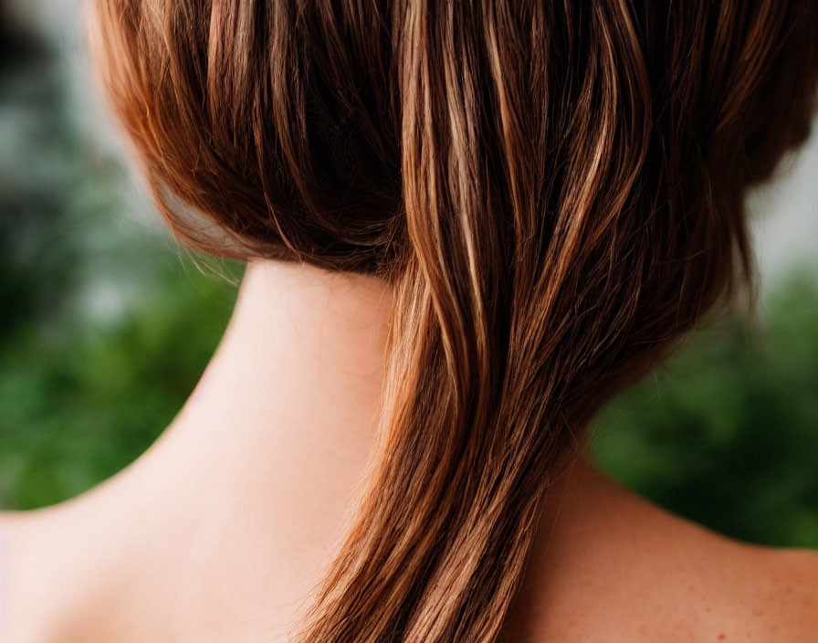 Person with Light Brown Ponytail, Ear, and Shoulders in Close-Up Shot