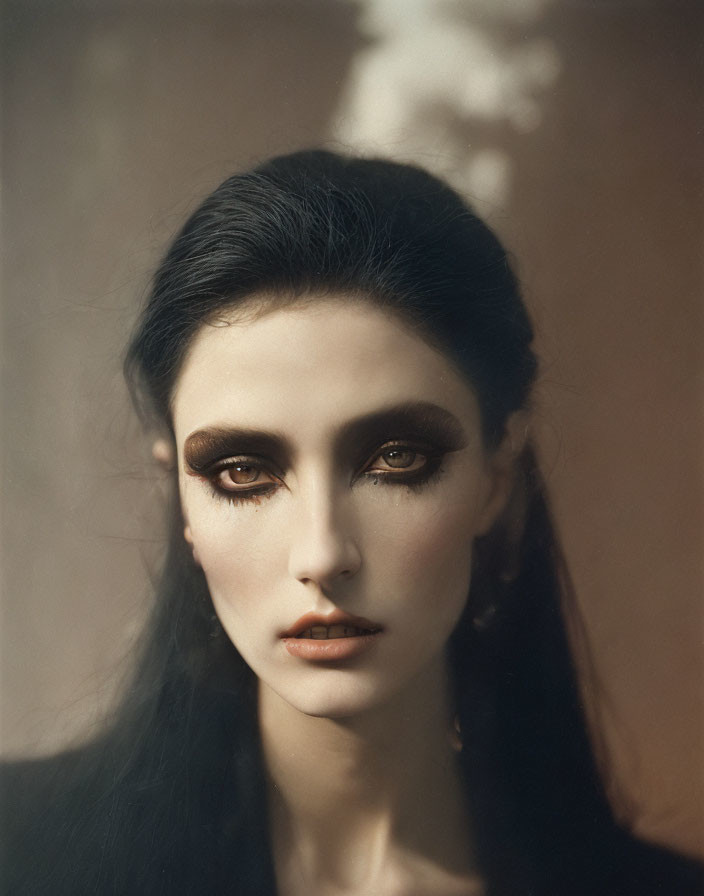 Dark-Haired Woman with Bold Eye Makeup and Pale Skin Portrait