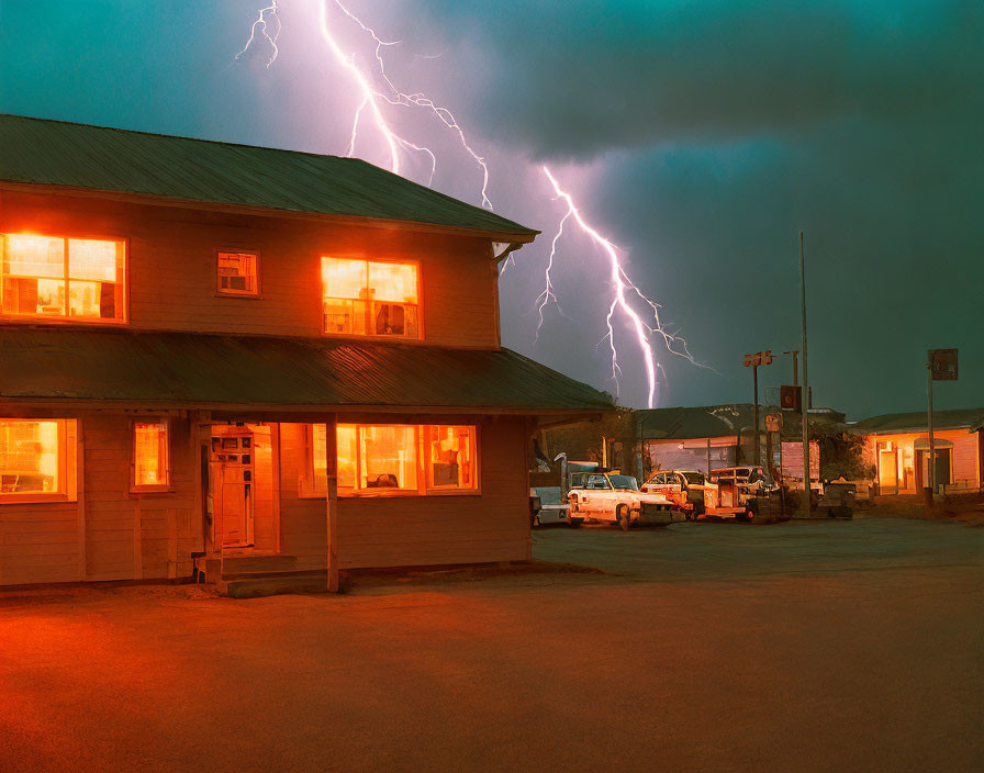 Two-story building with illuminated windows at dusk under stormy sky with lightning strikes