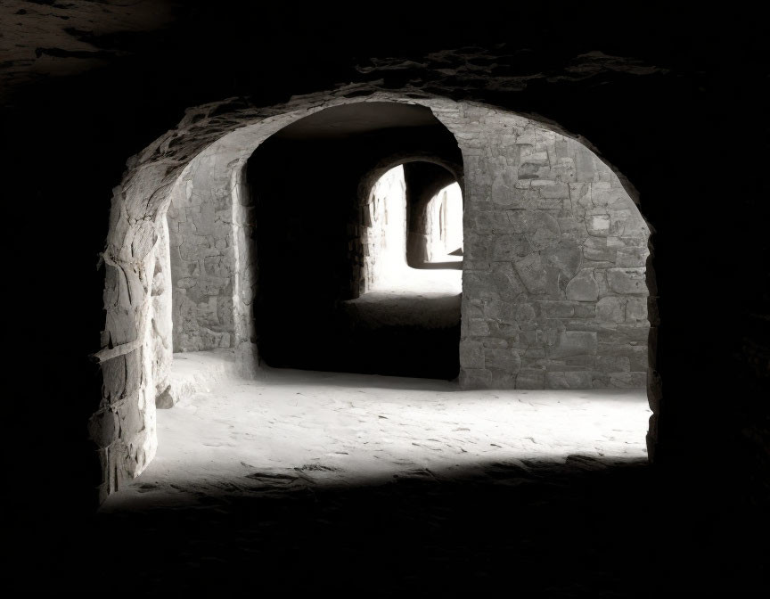 Stone tunnel with two bright archways in historic setting