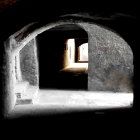 Stone tunnel with two bright archways in historic setting