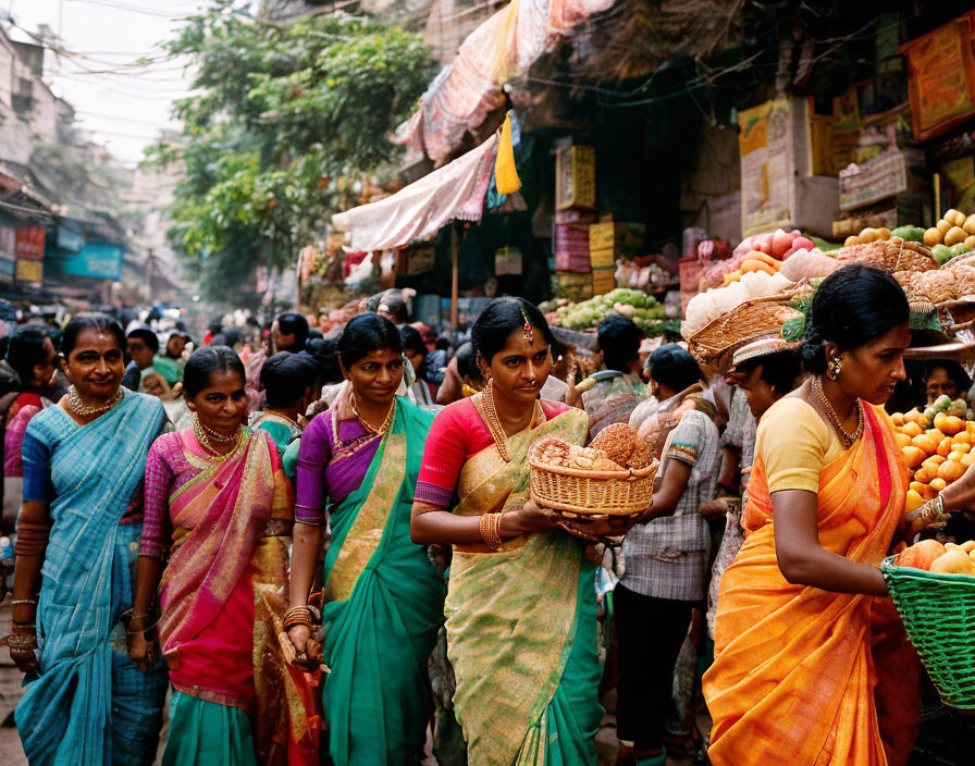 Traditional saris worn by women in a vibrant market scene.