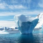 Serene Polar Landscape with Icebergs and Snowy Peaks