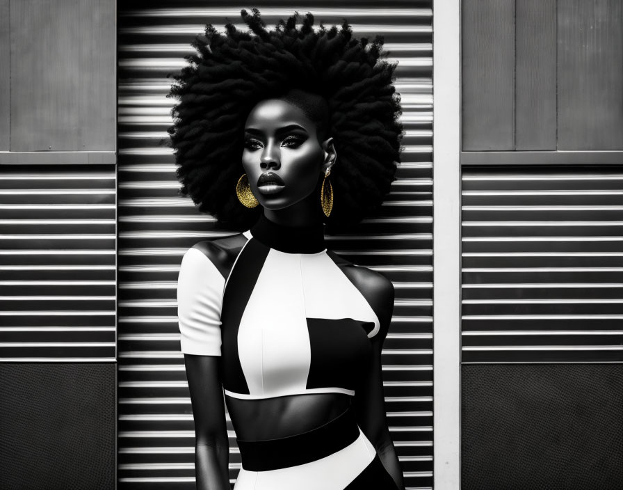 Monochrome image of woman with afro hair, patterned dress, gold earrings, against striped backdrop