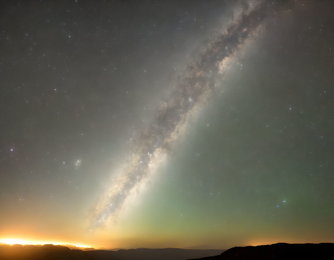 Starry Sky with Milky Way over Mountain Range at Sunrise or Sunset