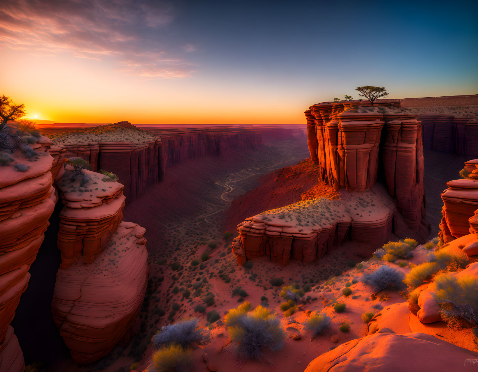 Desert canyon at sunset with sandstone cliffs and winding path