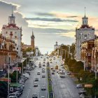 Colorful cityscape painting of bustling street at sunset