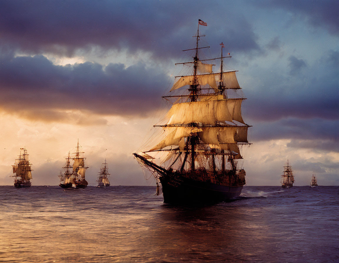 Tall Ships with Full Sails on Ocean at Sunset