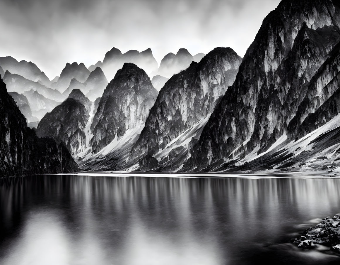 Monochrome landscape: serene lake, rugged mountain peaks