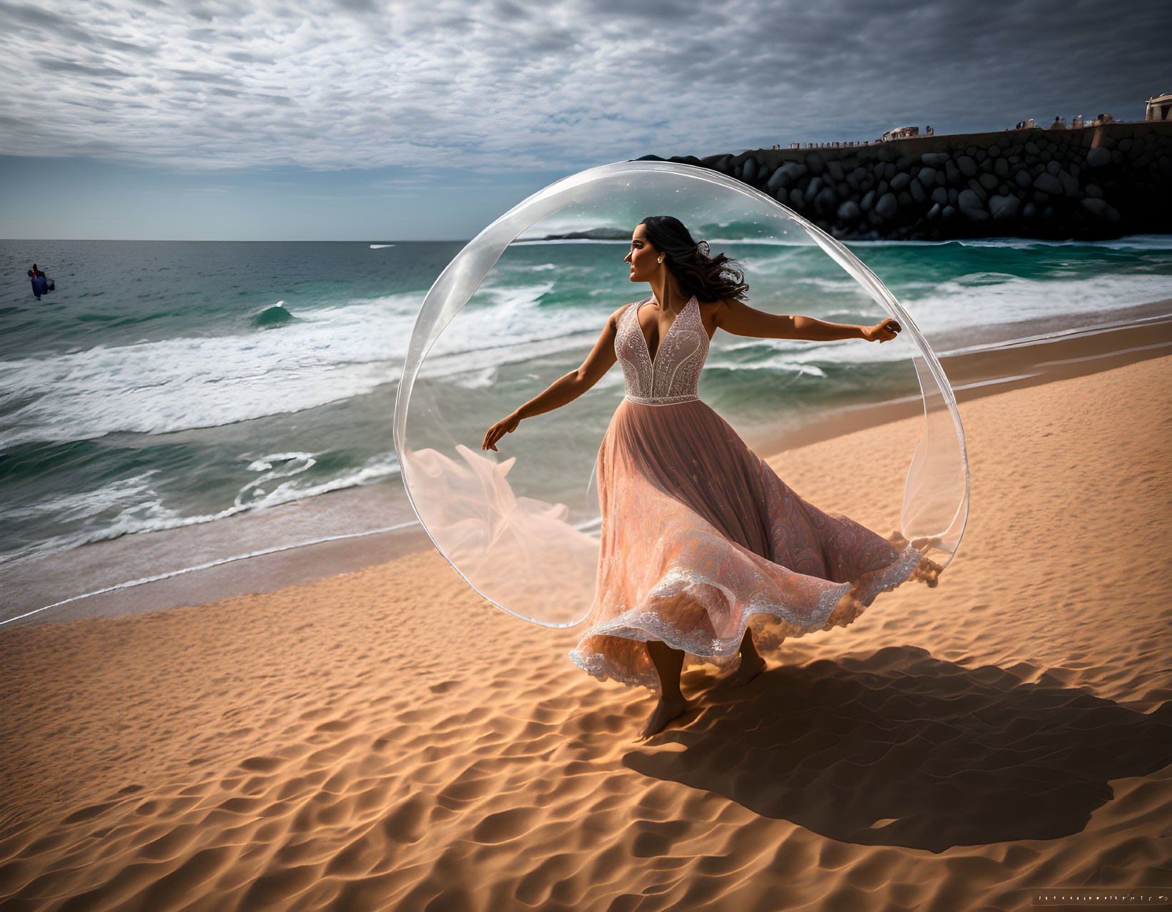 Woman in flowing dress inside transparent bubble on sandy beach with waves and jetty.