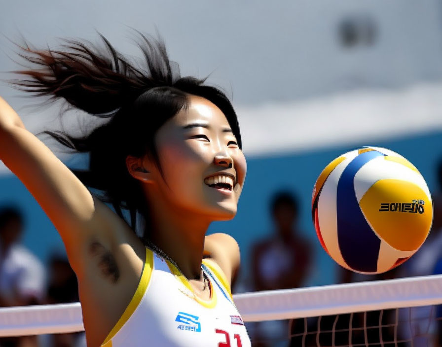 Smiling female volleyball player in yellow and white jersey with flying hair and moving ball