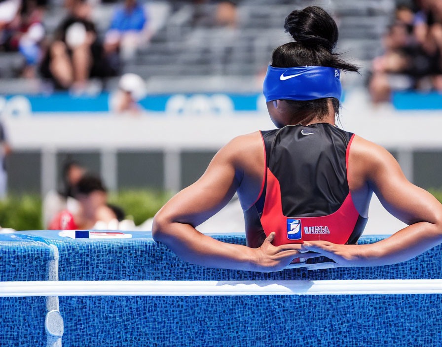 Female Athlete in Nike Outfit with Visor Prepares Trackside