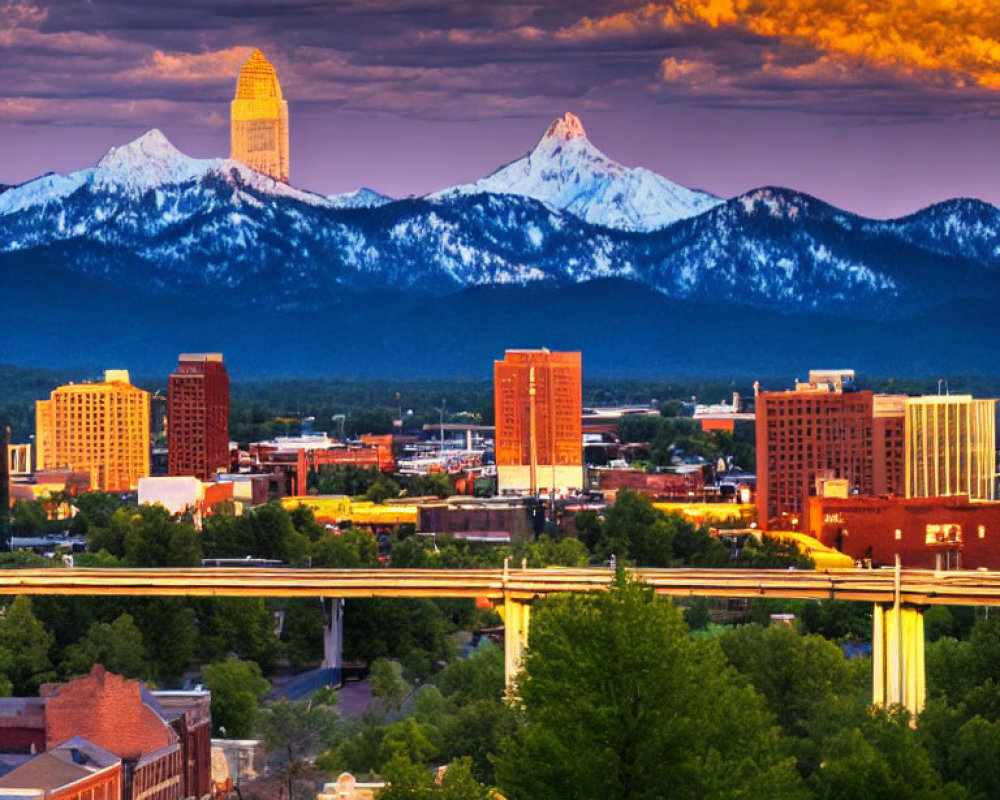 Modern city skyline with snowy mountains and vibrant dusk sky