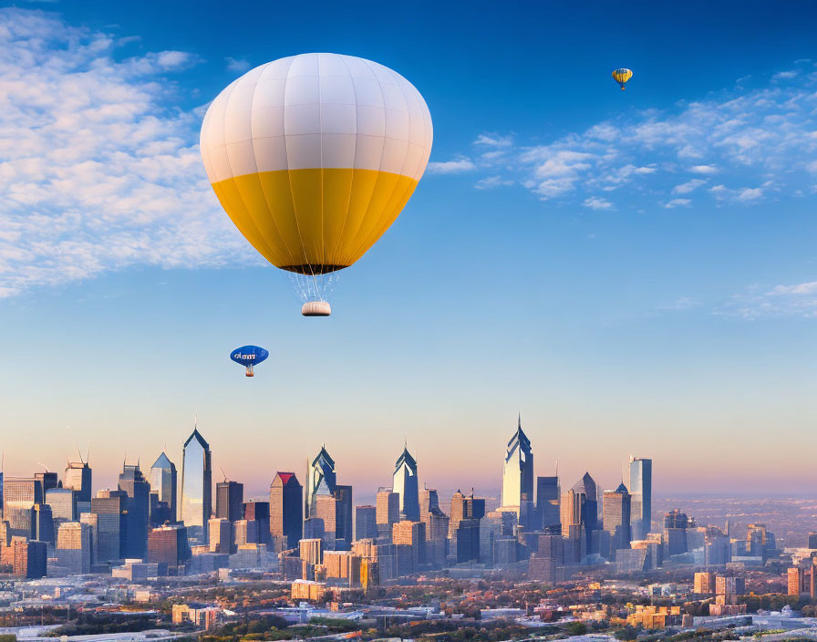 Colorful hot air balloons over urban skyline at sunrise or sunset