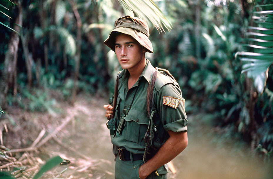 Camouflaged young soldier with helmet and rifle in dense foliage