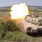 Futuristic tanks with urban camouflage firing in a field