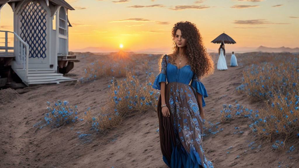 Woman in Blue Dress in Desert Sunset with White Structure and Blue Flowers