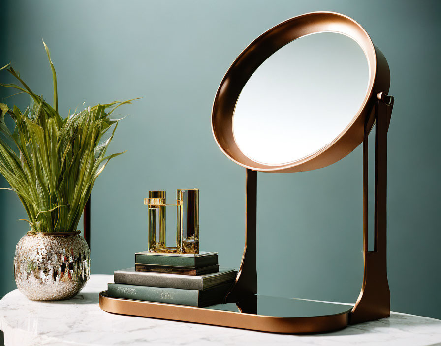 Circular mirror makeup vanity with books, plant, and decor on teal background